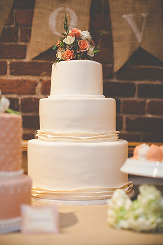 Simple White Wedding Cake Topped with Flowers
